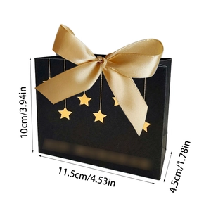 Schwarze Papiertüte mit goldenen Sternen und Satin-Schleife für elegante Geschenke