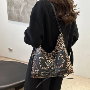 Fashionable leopard print tote bag with black butterfly patch and lace-up details