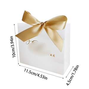 White party gift bag with gold bow and dimensions 10x11.5x4.5cm for castle theme events