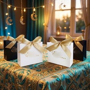 Detail of white and black Mubarak gift bags with gold satin ribbons and festive decor