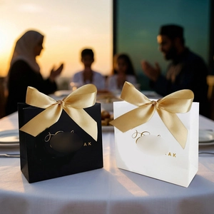 Elegant gift bags in black and white with gold ribbons for festivals and weddings