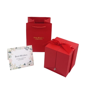 Red double-door jewelry gift box with ribbon, matching carry bag and greeting card
