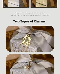 Detailed close-up of glitter wedding favor box with grey silk ribbon and gold pendants