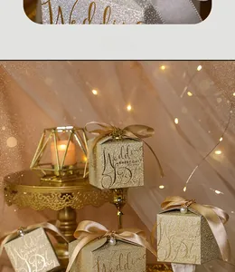 Detail of glittery champagne gold wedding gift box with satin bow and pearl accent