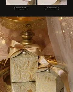 Close-up of golden glitter wedding favor boxes with satin bows and pearl charms