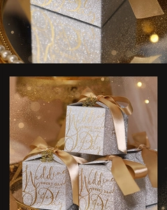 Macro view of silver glitter wedding favor boxes with gold accents and champagne ribbons