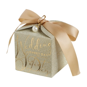 Sparkling champagne gold wedding favor box with glitter finish, ribbon and pearl charm