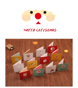 Close-up of assorted mini Christmas greeting cards with festive patterns on wood background