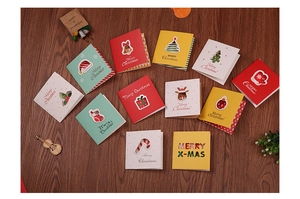 Detailed view of various colorful 3D Christmas cards with festive motifs on wood background