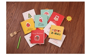 Detailed view of assorted mini Christmas cards with festive patterns on wood background