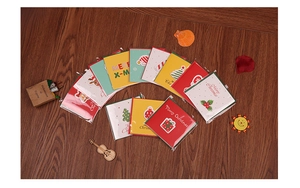 Flat lay of colorful Christmas greeting cards with reindeer and tree motifs on wood