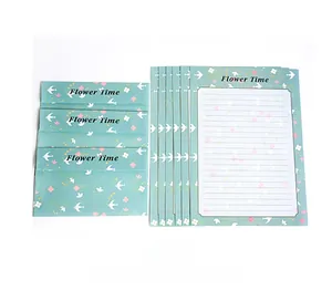 Detailed view of pastoral stationery set featuring white birds and yellow flower patterns