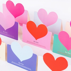Colorful heart-shaped folding gift cards with Love Love text on white background