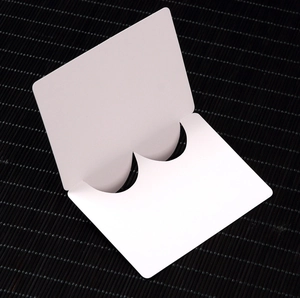 Minimalist white cardboard folding card with dual semicircular slots for jewelry display