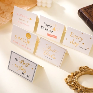 Detailed view of assorted minimalist greeting cards with gold foil and heart patterns