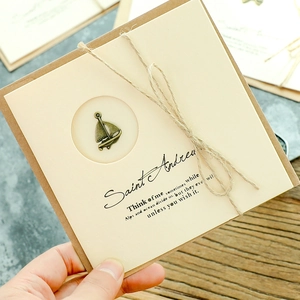 Vintage kraft paper greeting card with sailboat bronze charm and twine wrap