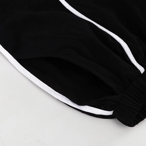 Detail van zwarte gebreide shorts met elastische taille en zijstrepen op katoenmix stof