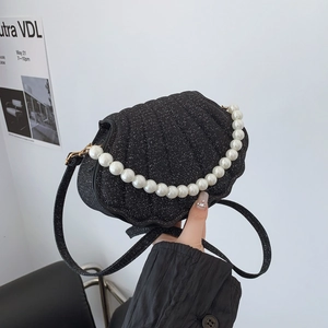 Chic black shell-shaped crossbody bag with glitter finish and pearl handle strap
