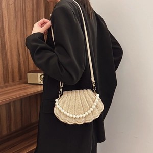 Golden pearl shell shoulder bag with metallic shimmer texture and elegant pearl handle