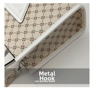 Close-up of floral print tote bag featuring silver metal hooks and white leather piping