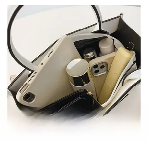Spacious interior of black and white tote bag showing storage for tablet and essentials