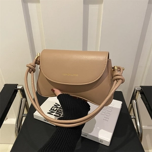 Minimalist khaki leather flap crossbody bag with gold fashion lettering and knotted shoulder strap