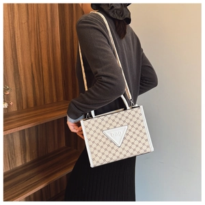 Detail view of large tote bag with star pattern and branded logo tag for women