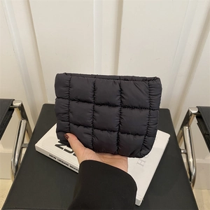 Minimalist black quilted cosmetic bag in nylon fabric with puffer design for women