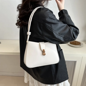 Minimalist white faux leather shoulder bag with top knot handle and vintage bronze lock