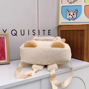 Detail of soft cream plush backpack with brown puppy ears and adjustable straps