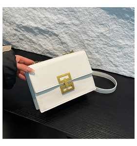 Close-up of white square shoulder bag with gold metal clasp and textured PU leather