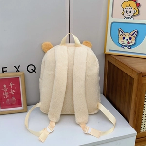 Detail of plush cream backpack featuring soft straps and cute bear ear design