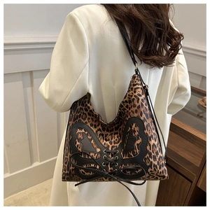 Detailed side view of large leopard print tote bag with butterfly patch and lacing