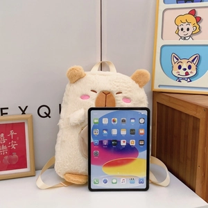 Cute Capybara plush backpack in beige faux fur beside an iPad for size comparison