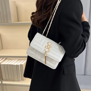 Elegant white quilted crossbody bag with golden letter buckle and chain tassel detail
