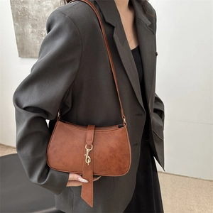 Vintage brown baguette shoulder bag with gold metal hook buckle and textured faux leather