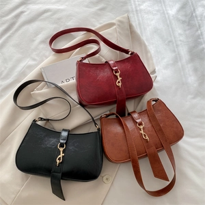 Chic retro baguette bags in burgundy, black, and caramel with unique metal hook closures