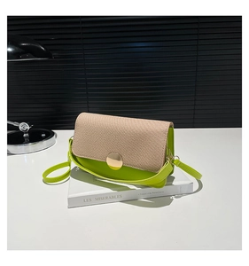 Detail of color-block crossbody bag featuring green leather and beige woven texture