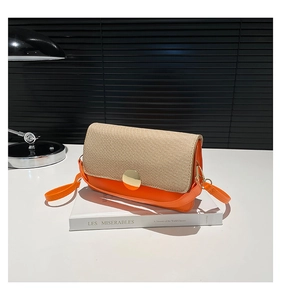 Detail of contrast stitch handbag with beige straw texture flap and orange leather base