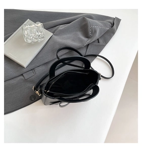 Top view of the black square bag showing interior compartments and zipper closure detail