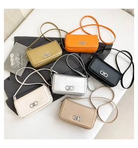 Flat lay of small crossbody bags in six colors with metallic details and slim straps