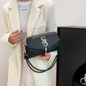 Retro black leather crossbody bag with gold tassel logo and crocodile texture panels
