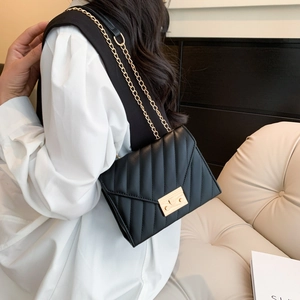 Black quilted crossbody bag for women with gold chain strap and metallic lock clasp