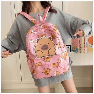 Detail of pink backpack with cute capybara print shown on a model for scale and fit