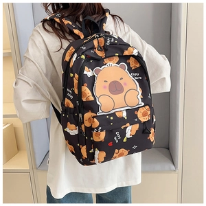 Close-up of black backpack with cute capybara prints and large pocket on a model