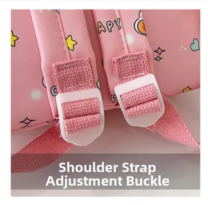 Detail of adjustable shoulder strap buckles on a pink cartoon backpack with star patterns