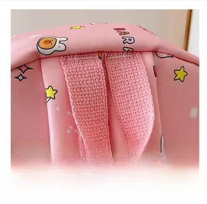Close-up of reinforced pink handle and cartoon star prints on kids backpack
