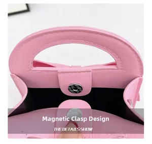 Detail showing the magnetic snap closure on the pink PU leather bow handbag for kids