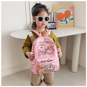 Detailed view of pink capybara cartoon backpack worn by child in a modern home setting