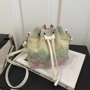 Close-up of tie-dye star pattern and frayed edges on a stylish canvas bucket bag